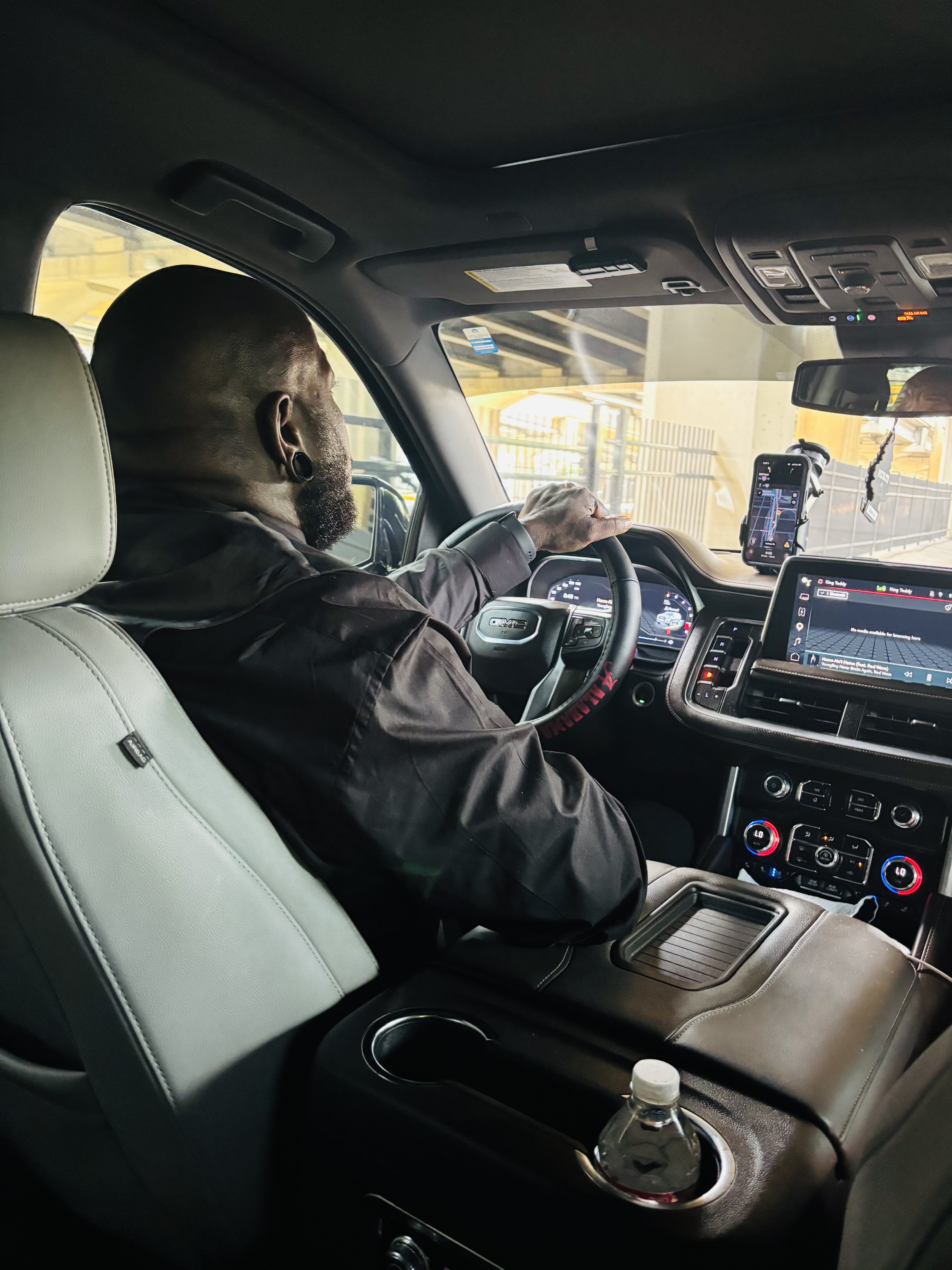 Chauffeur at the wheel of a luxury SUV with a private cabin view